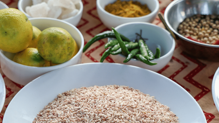 Various spices placed on the table Three women enjoying food in an open setting at the Sylvan Retreat, Dehradun.