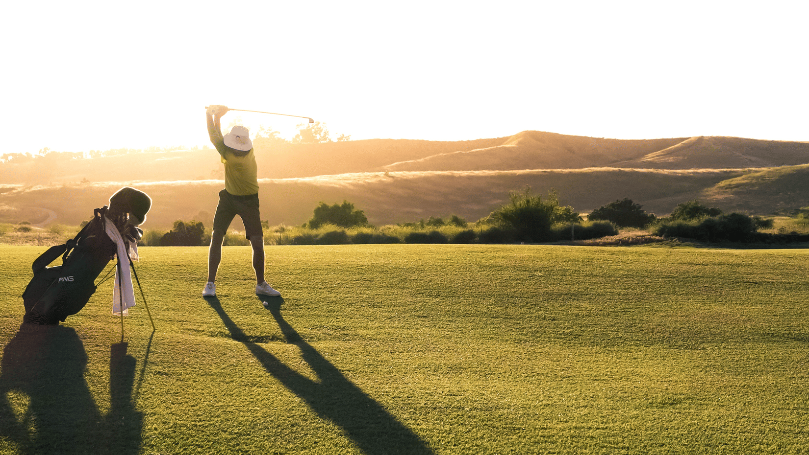 A man plays golf at a spacious lush green golf course - things to do in Whitefield Bengaluru