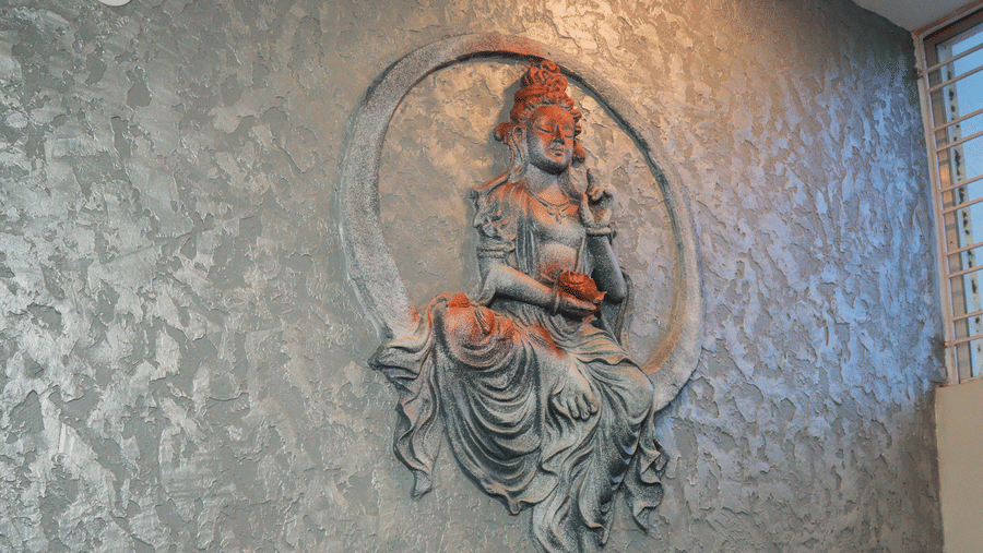 A stairway at Dip Holidays featuring a textured wall with an illustration on it.