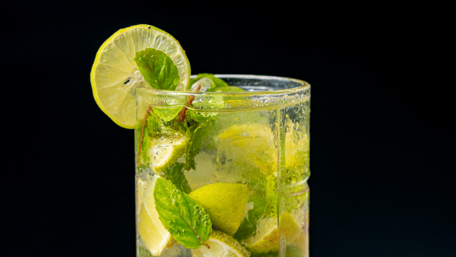 A layered mint and lime mocktail served at Café Latte, located within Noor-Us-Sabah Palace, Bhopal, garnished with a fresh lemon slice.