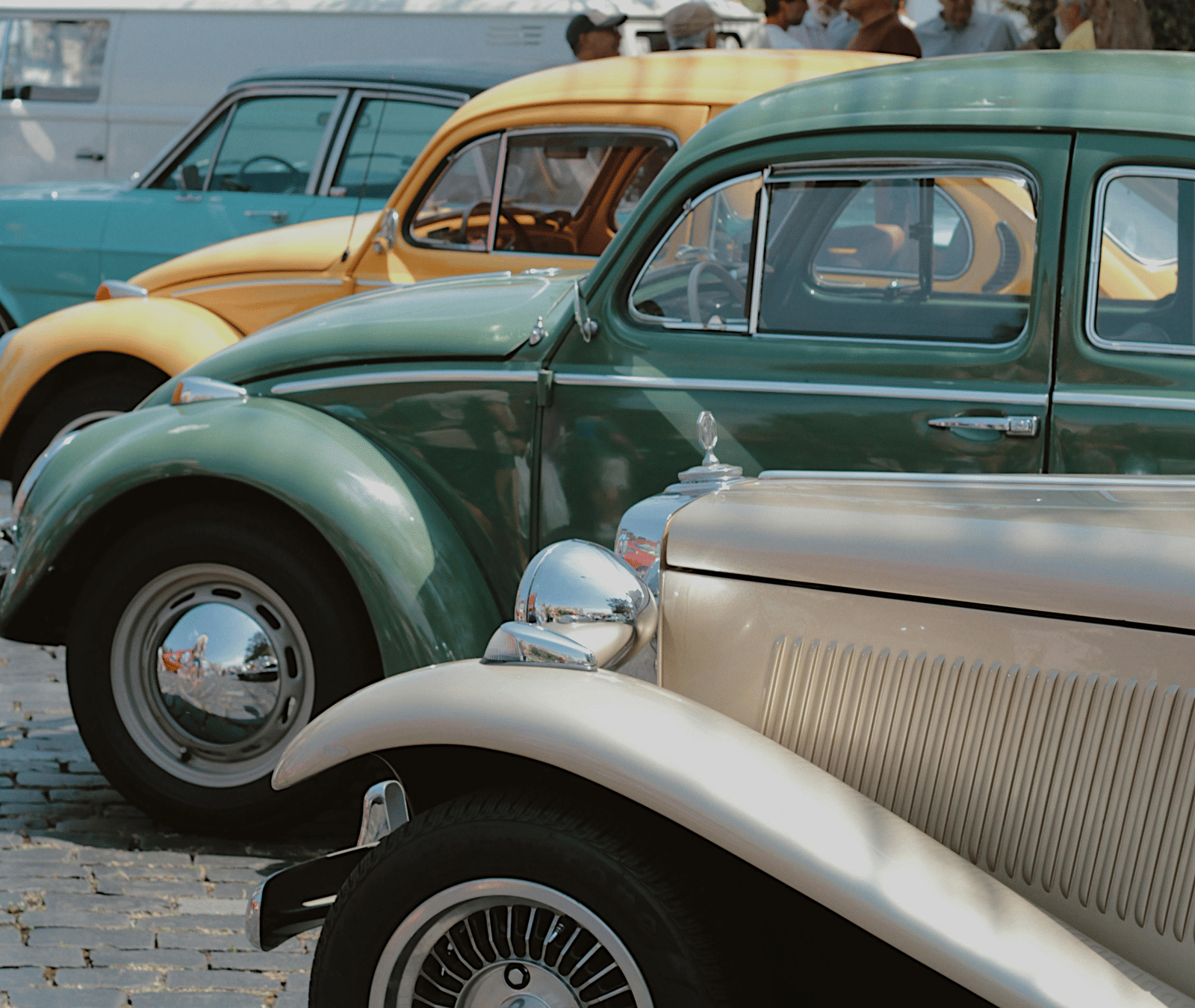 Vintage cars parked on a street, likely from an old Indian city.