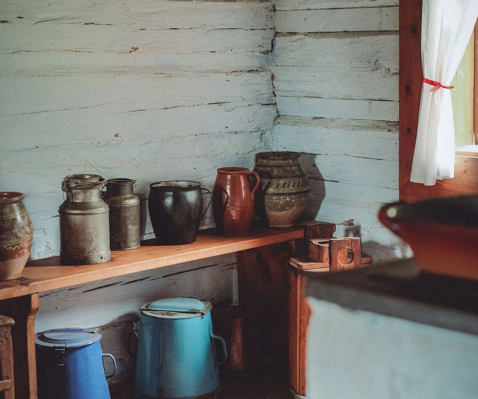 an overview of a room filled with clay pots kept on a wooden table