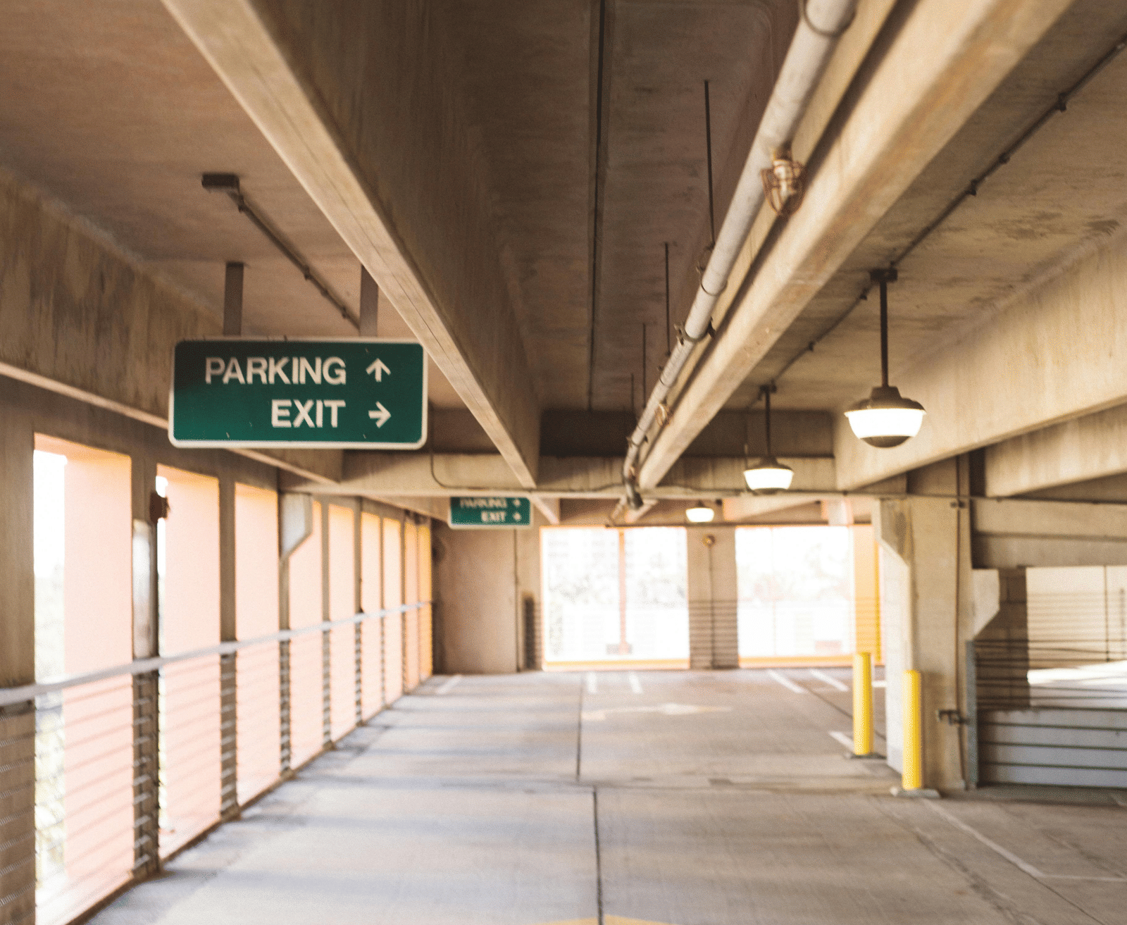 Basement parking area with directional signage of 'Parking' and 'Exit'.