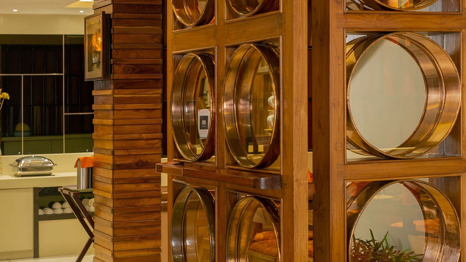 Door to Honeycomb Restaurant at Coral Reef Hotel & Spa in Port Blair with mirrors attached 