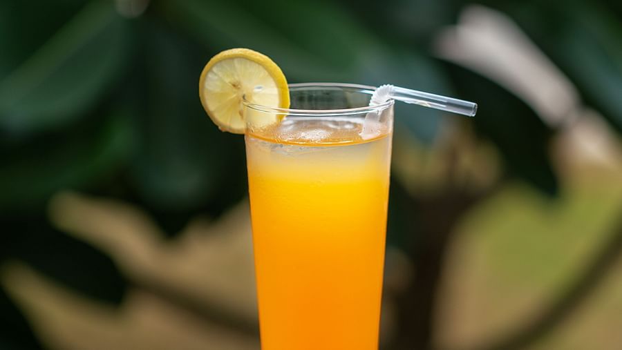 image of a refreshing cool cocktail with a fusion of orange and red colour with a straw inside the glass
