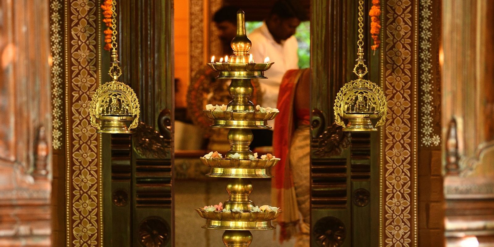 image of a branze oil lamp at the enterence of hoysala village resort, hassan