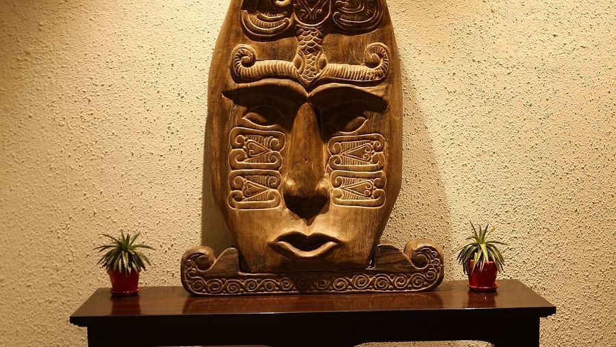 Tribal wooden décor resembling a face - Rhythm Lonavala