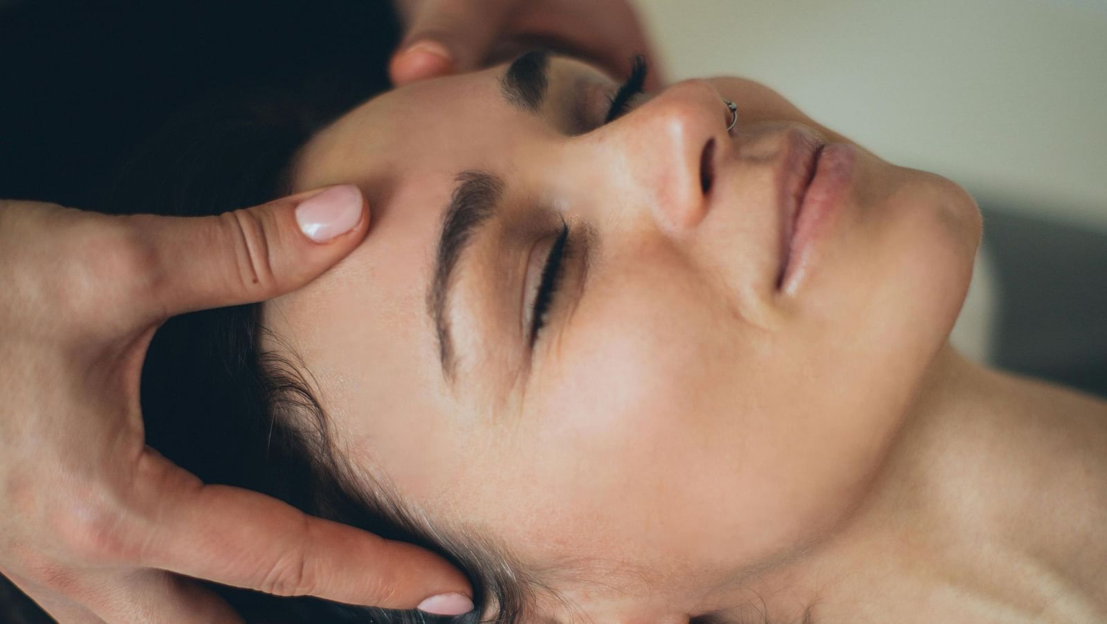 A shot of a lady receiving head massage.