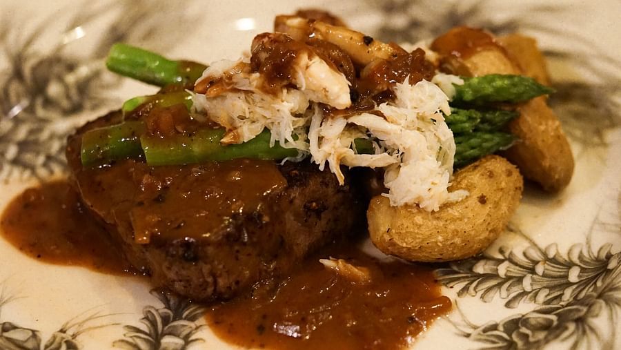 A mouthwatering gourmet dish featuring a tender cut of beef served with vegetables and a flavorful sauce - Brewery Gulch Inn & Spa