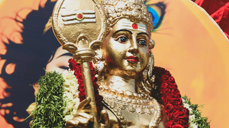 Decorated idol of Lord Murugan adorned with floral garlands during a celebration