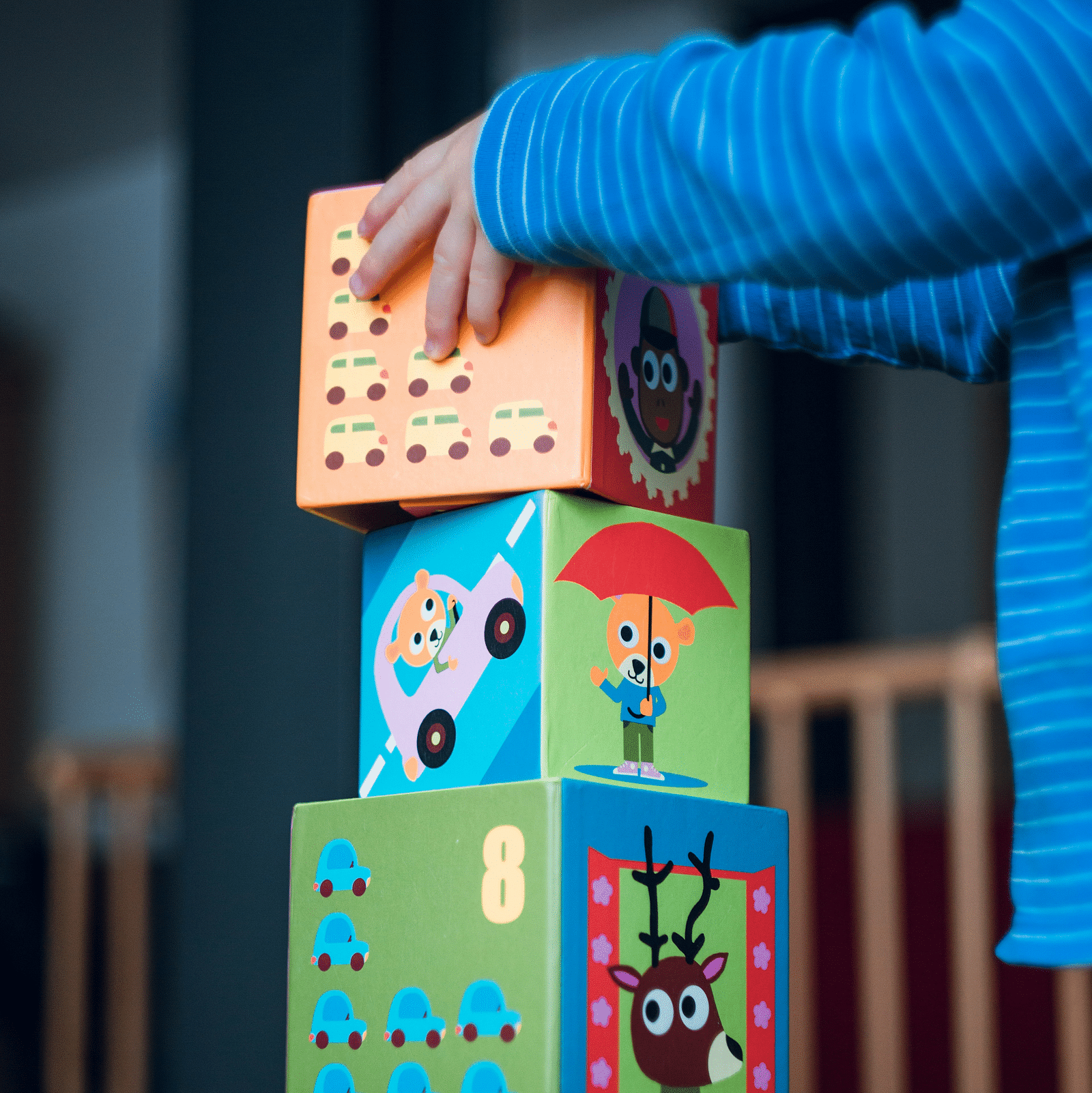 A young kid arranging blocks while playing