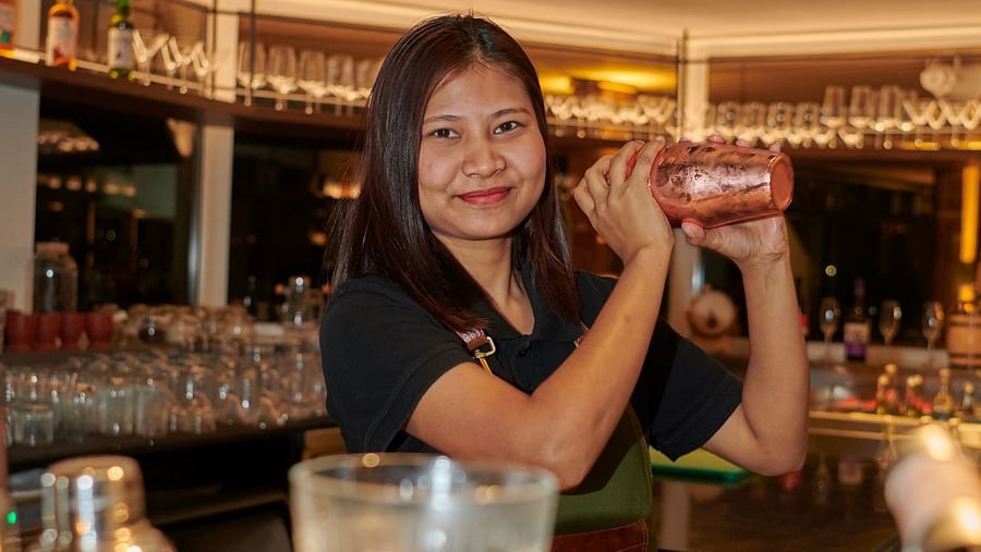 an image of a female bartender preparing a drink at an image of a male bartender displaying his skills at The Dukes Retreat
