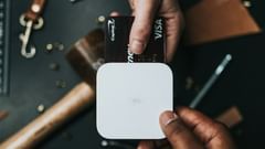 An aerial view of a person paying for an item at a shop using their card.