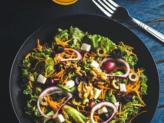 Top view of a salad bowl along with a glass full of tangerine juice - Stone Wood Mountain Resort, Dharamshala
