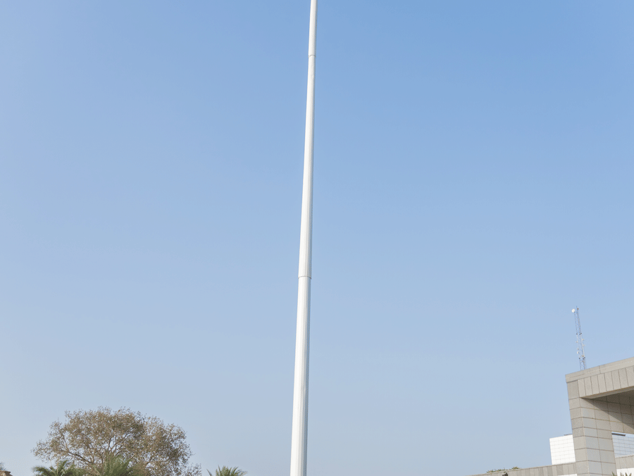 A group of people standing in front of the Indian flag - Karma Lakelands.