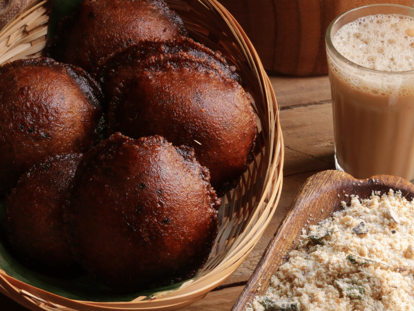 Indian sweets and savouries served with a glass of milk beside festive decorations
