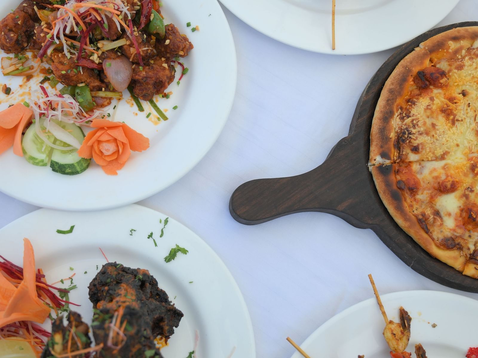 A vibrant spread of Indian dishes beautifully presented at Royal Comfort Regency, perfect for food lovers exploring local cuisine.