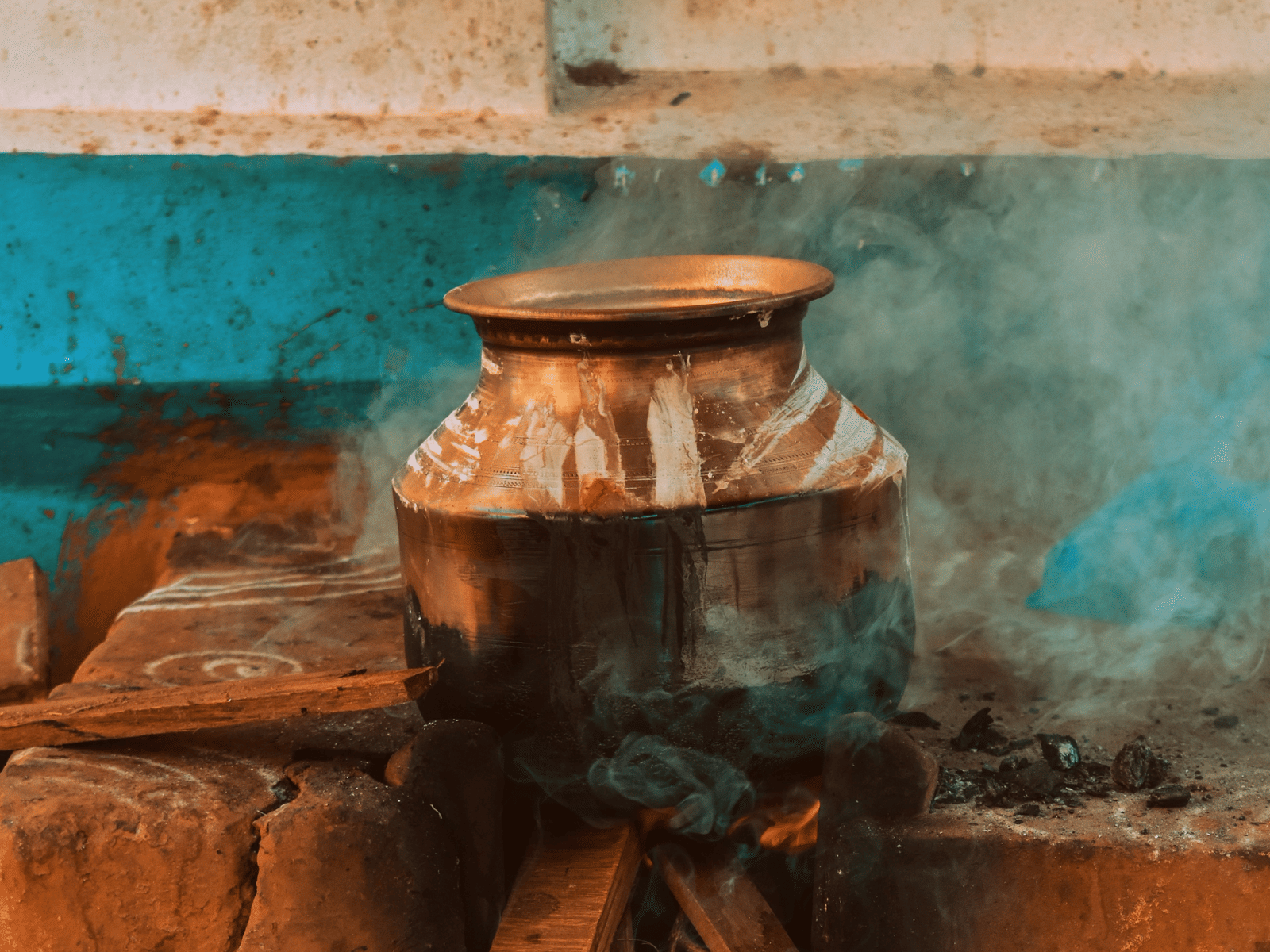 A view of a claypot being cooked outdoor with logs during Pongal in Chennai.