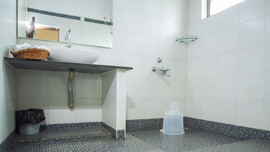 Overview of the bathroom in one of the rooms at Capitol Village Resort, Madikeri