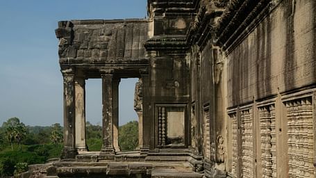 A historic stone edifice with intricate carvings showcases arched doorways and detailed columns.