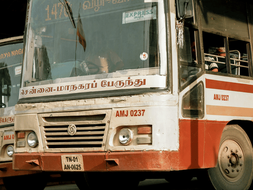 A local Chennai bus on a bus stand .