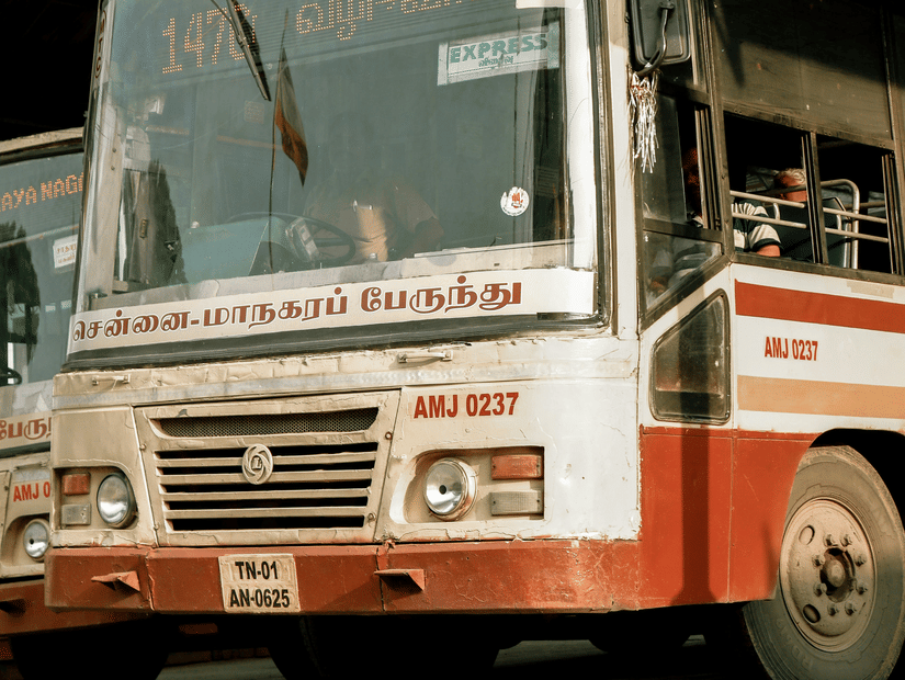 A local Chennai bus on a bus stand .