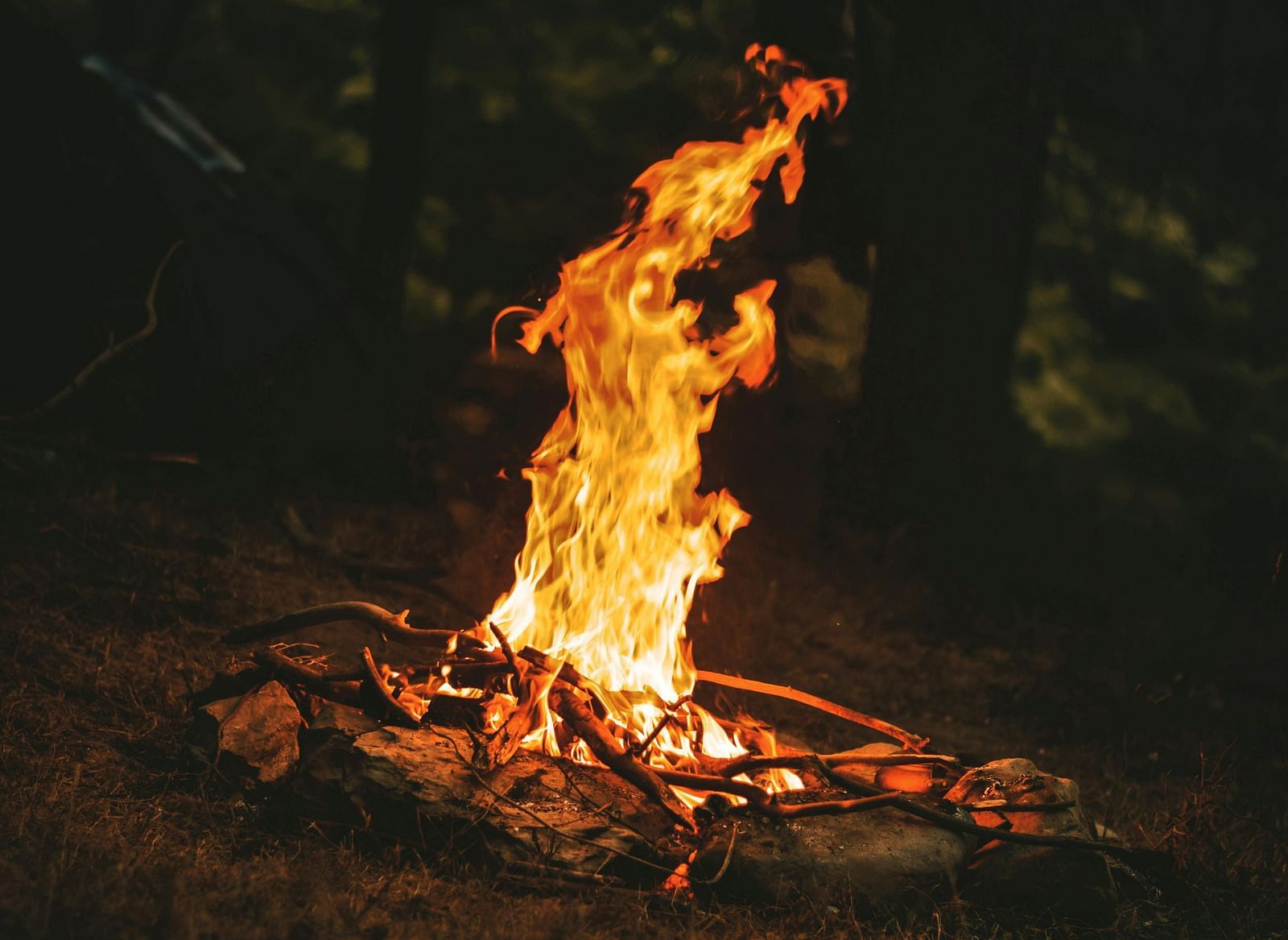 A bonfire set in the dark.