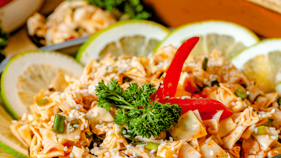 A seasoned shredded salad garnished with lemon slices and fresh herbs at Marble Arch, located within Noor-Us-Sabah Palace, Bhopal, served on a buffet platter.