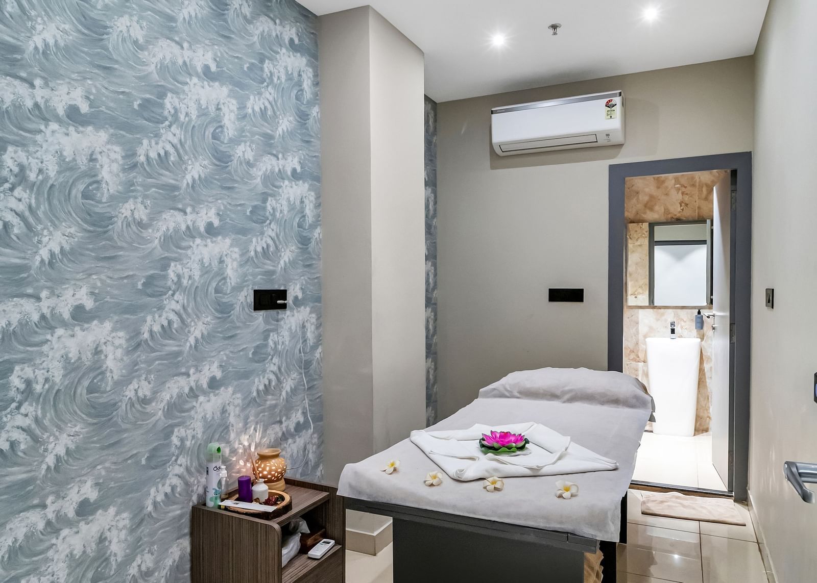 A spa or massage room with a treatment table, patterned wallpaper, and soft lighting  | The Citi Residenci Hotel Banskopa
