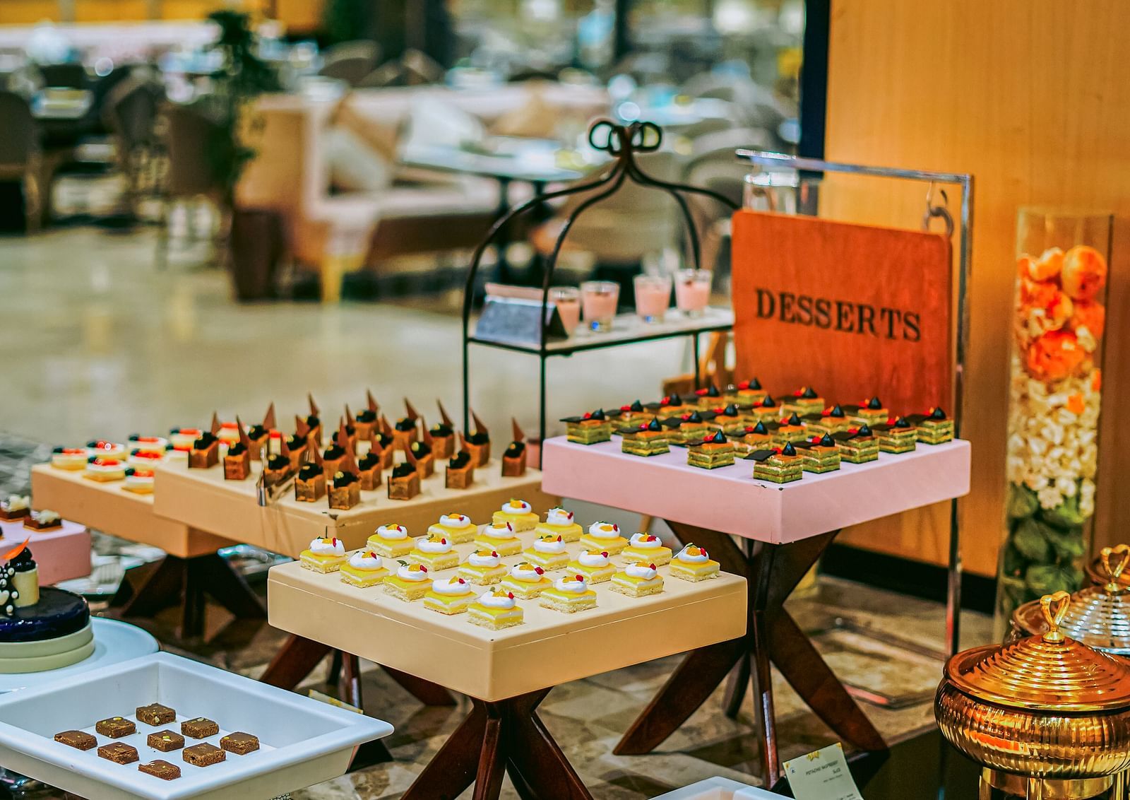 An appetising buffet spread with a variety of desserts neatly arranged on the table - Grand Madurai by GRT Hotels