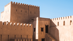 A fort with doors and steps leading to different rooms inside and the blue sky in the background