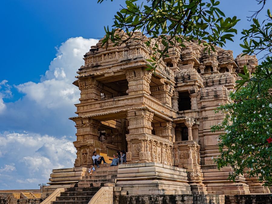view of a brown-shaped exterior facade of a fort standing amid greenery