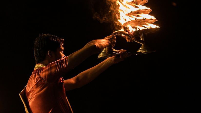 an image of a man perforrming aarti