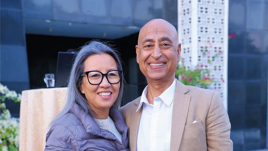 Picture featuring two people posing for the picture in the bright day light