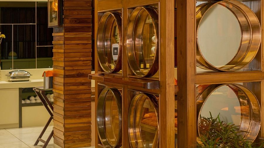 Door to Honeycomb Restaurant at Coral Reef Hotel & Spa in Port Blair with mirrors attached 