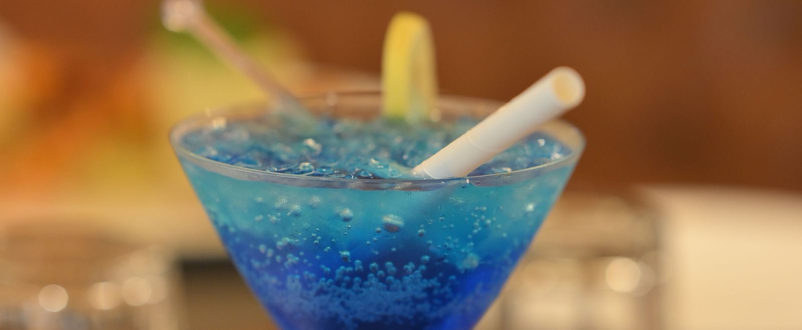 Refreshing blue mocktail garnished with citrus, served in a cocktail glass at Royal Comfort Regency, perfect for a relaxing evening.