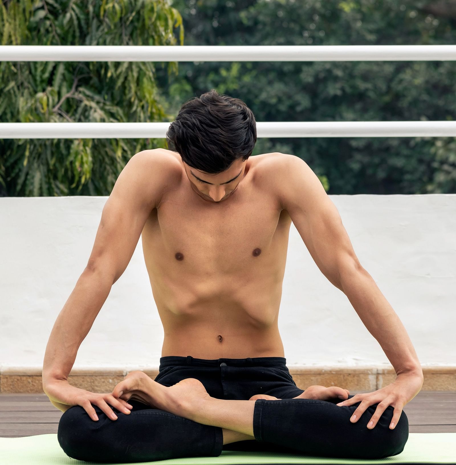 A man practising yoga in a serene environment