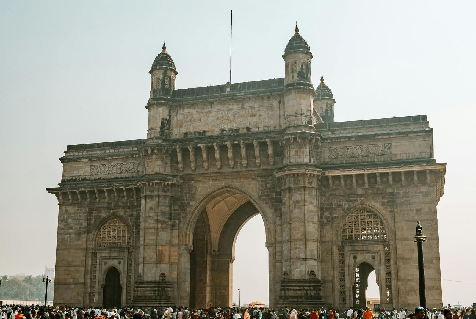 Shot of Gateway of India with visitors going around.
