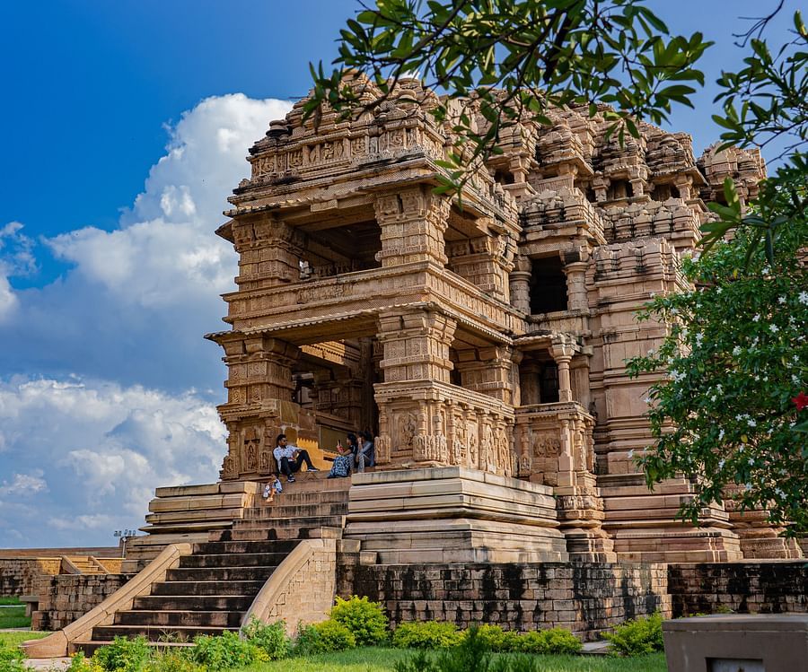 view of a brown-shaped exterior facade of a fort standing amid greenery