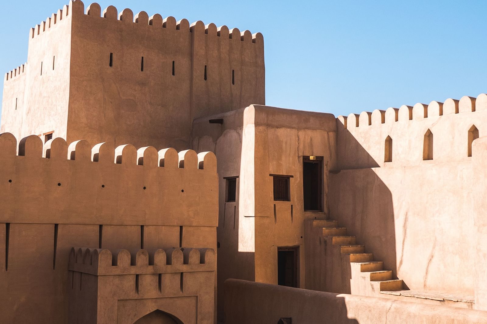 an image of fort with doors and steps leading to different rooms inside with the blue sky in the background