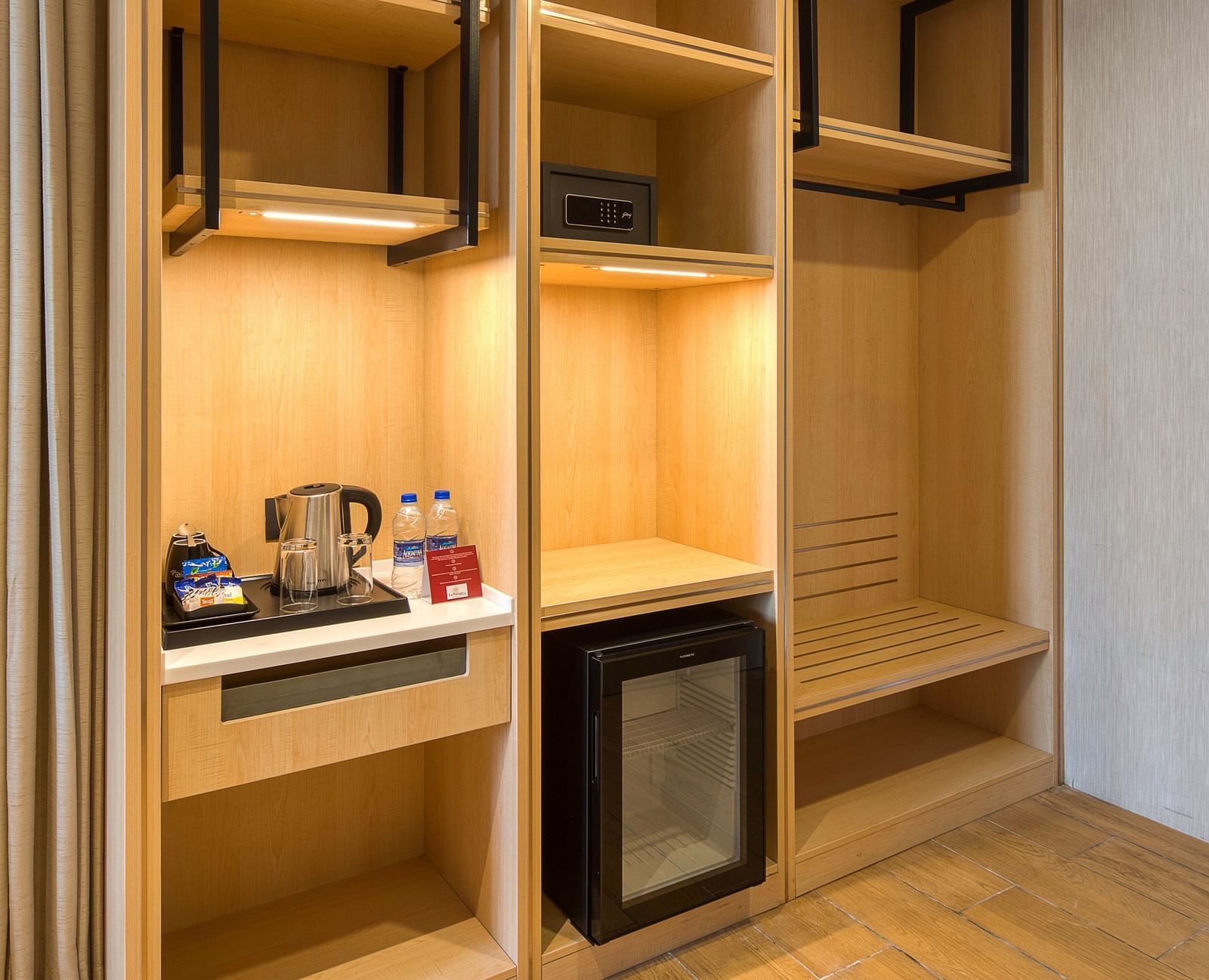 A cupboard at Executive Room at Le Foliage with a minibar and a tea and a coffee maker