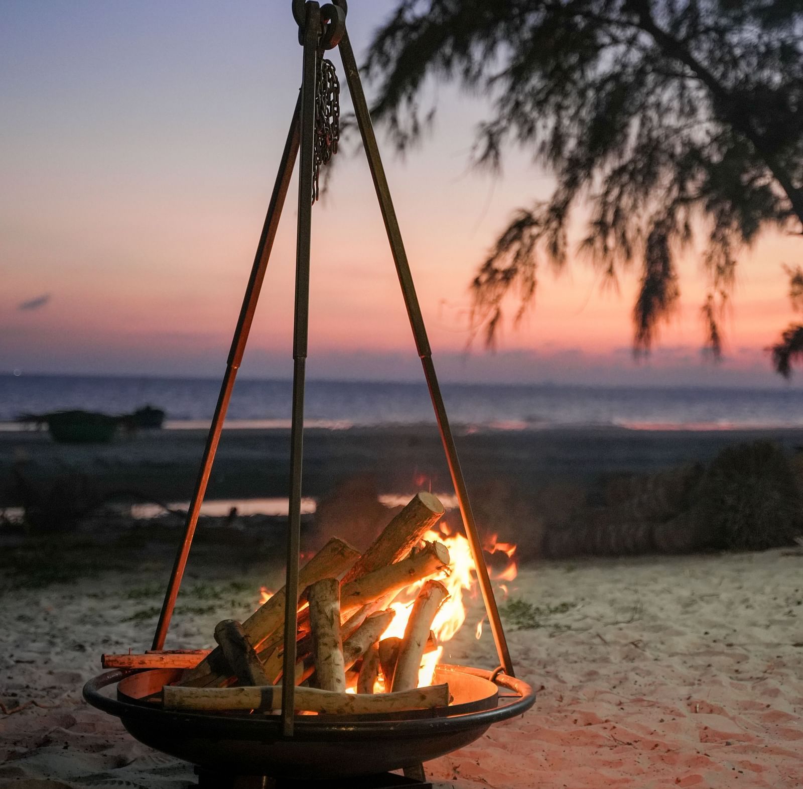 A bonfire setup by the beach at WoCAL Retreat Ke Ga, creating a relaxing atmosphere under the open sky.