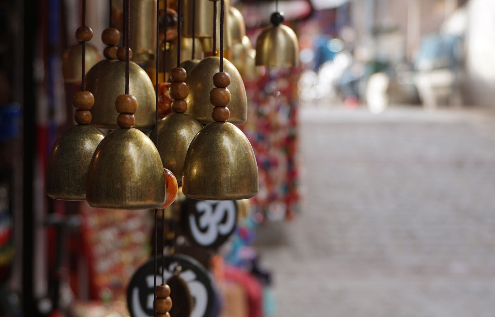 bells hanging from a shop on the road