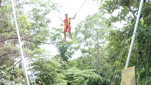 A thrilling bungee jumping setup amidst lush greenery at Black Thunder, Coimbatore.