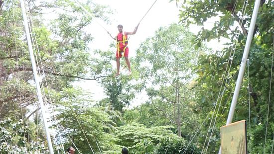 a person hung above during the BUNGY EJECTION ride - Black Thunder, Coimbatore