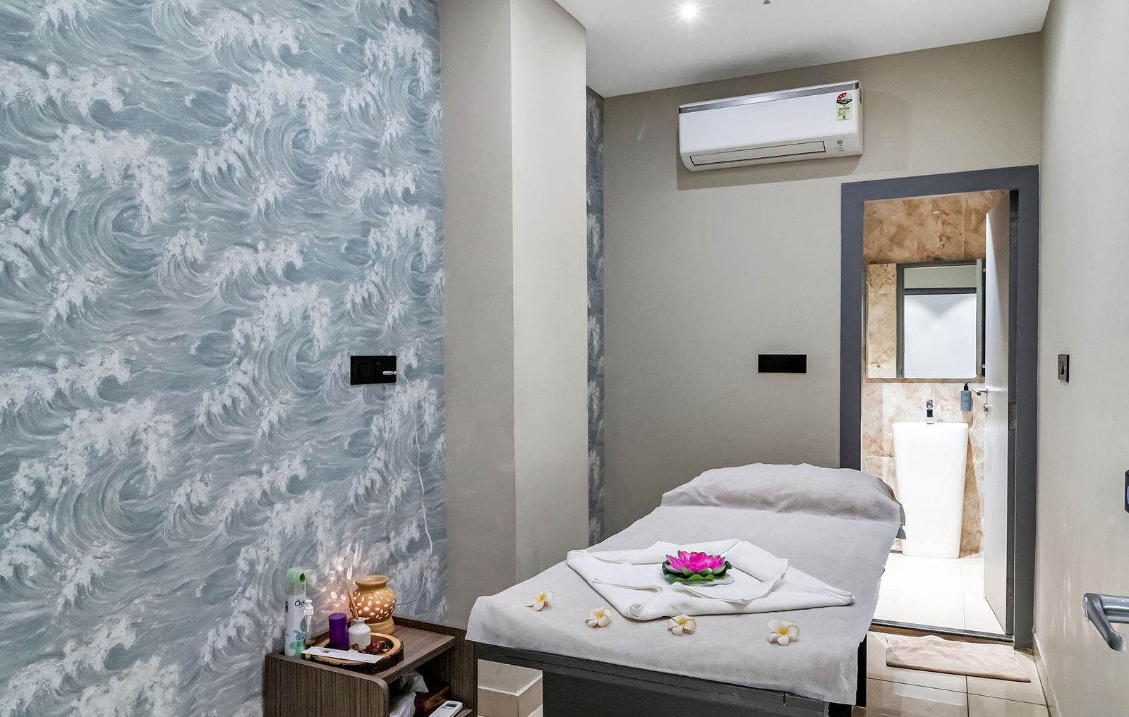 A spa or massage room with a treatment table, patterned wallpaper, and soft lighting  | The Citi Residenci Hotel Banskopa