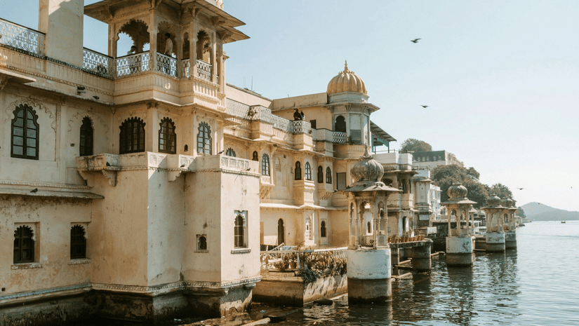 Side angle view of the exterior of Bagore Ki Haveli on the riverfront of Lake Pichola.
