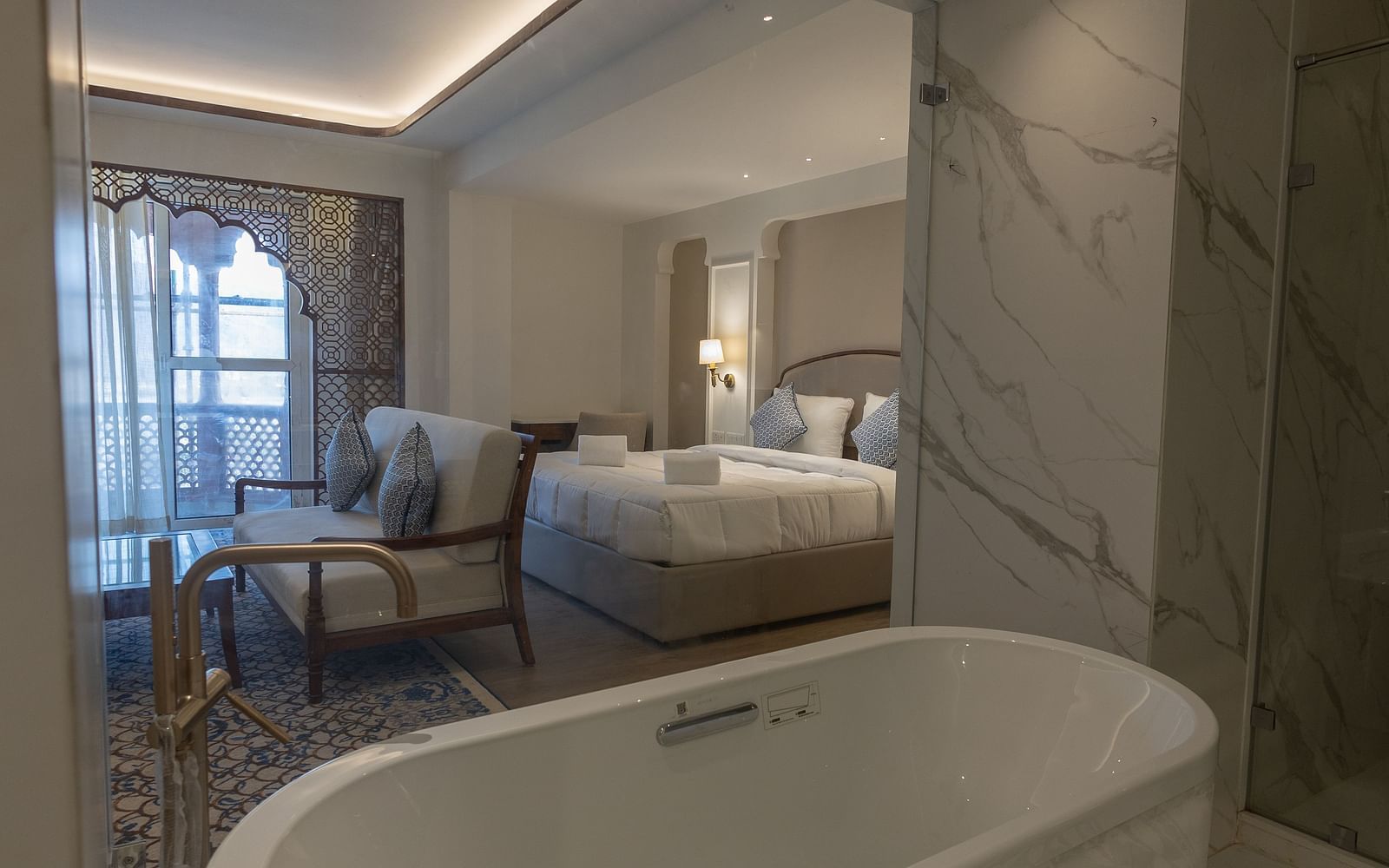 A close up shot of the bathtub overlooking the Purna Room at Bhagirathi by RDB Atishay through the glass partition.