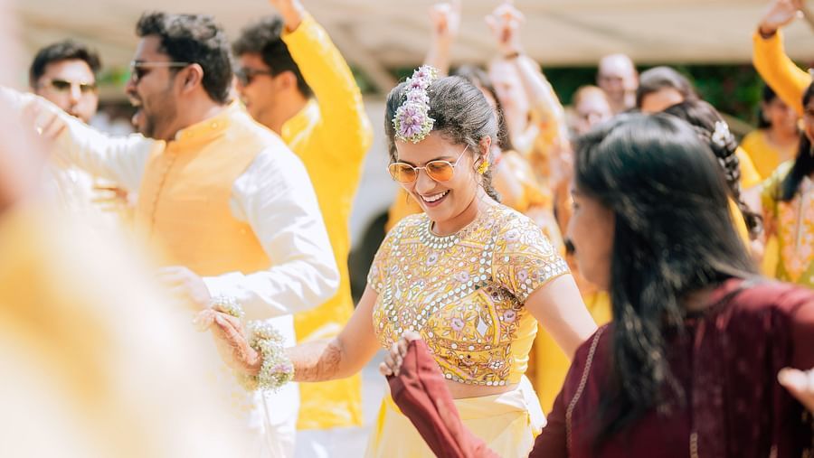 image of the bride dressed in a beautiful yellow gown dancing at darza resorts