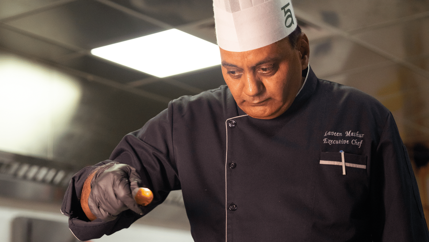 A chef working in a kitchen at Ananta Spa and Resort, Ajabgarh